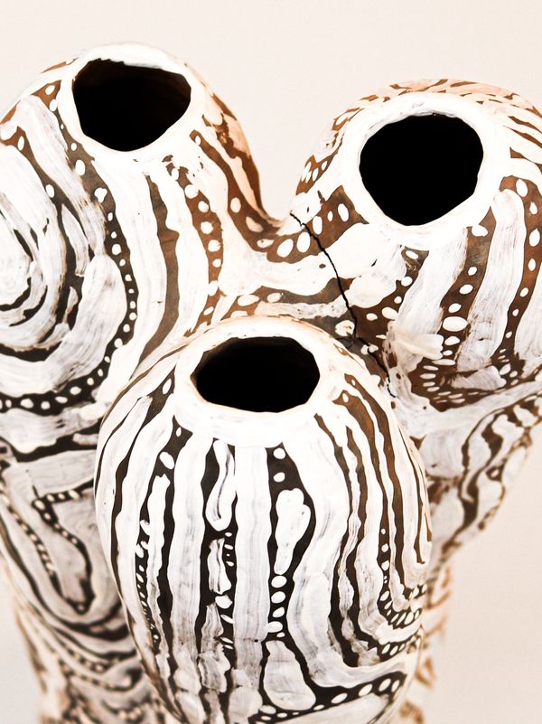 photograph of earthen ceramic sculpture, hand painted with patterns, close up aerial view, thumbnail