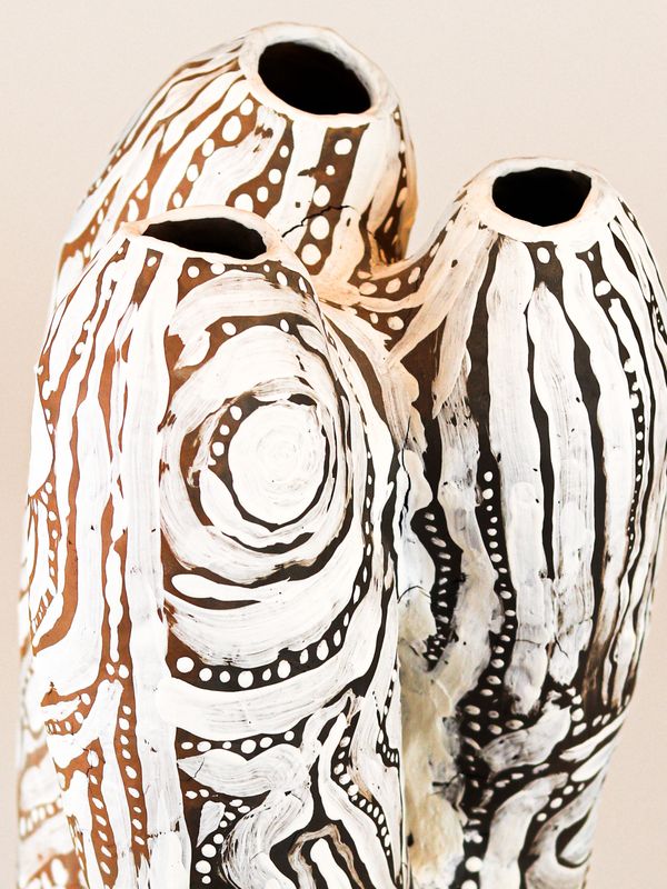 photograph of earthen ceramic sculpture, hand painted with patterns, close up view, thumbnail